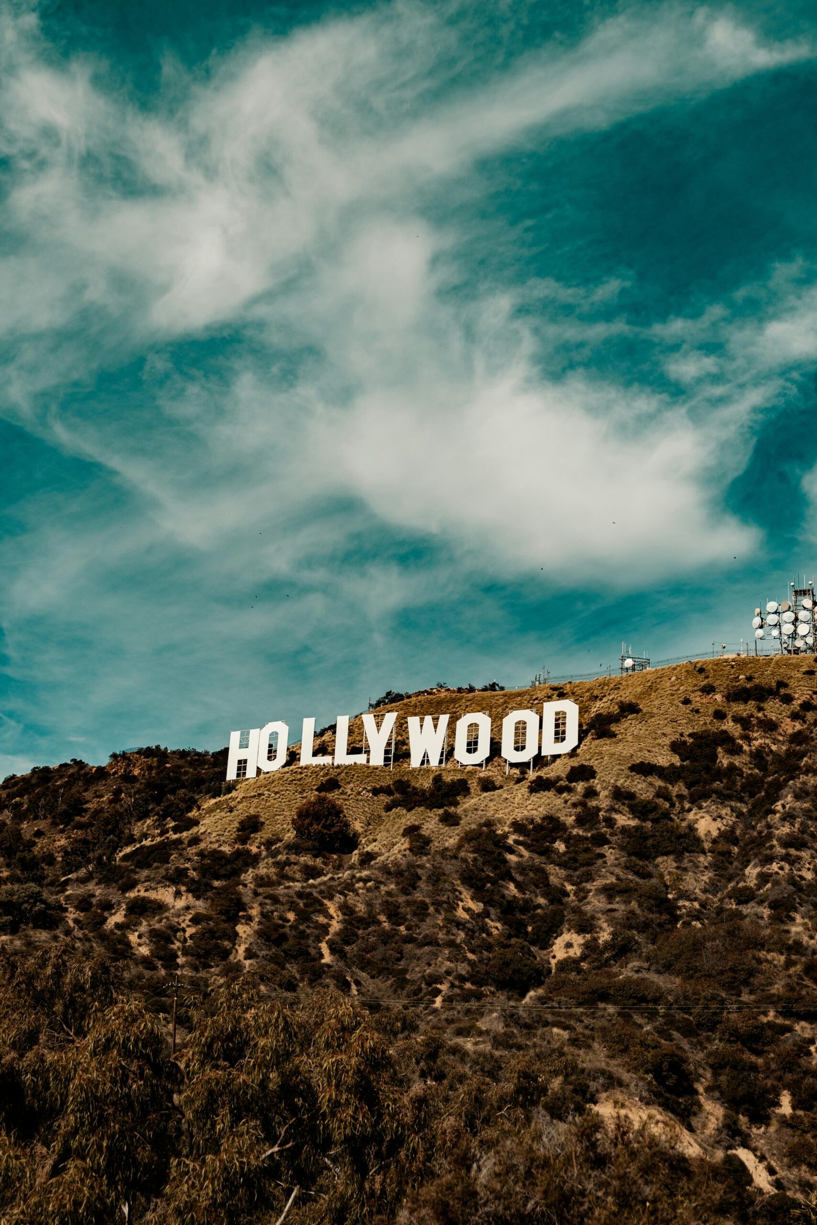 Scenic view of the iconic Hollywood sign under a blue sky in Los Angeles.